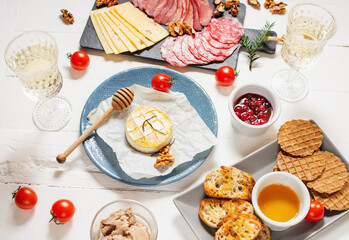Antipasto platter cold meat with bread, salami, slices ham and cheese on wooden background