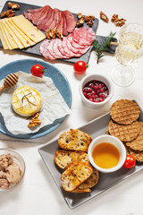 Antipasto platter cold meat with bread, salami, slices ham and cheese on wooden background