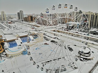 Ferris wheel in Tatarstan Kazan winter Aerial view. Flying over. Snow aquapark