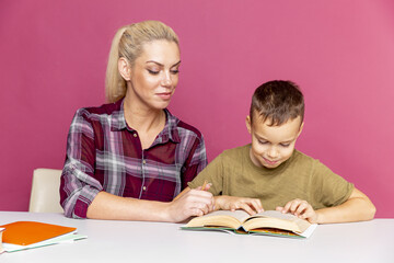 Fototapeta na wymiar Mother and son doing homework together. Education at quarantine time