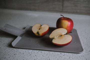 red apple on a cutting board. Shape of the heart