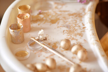 Fototapeta na wymiar Easter card background. Minimalism beige colors. Golden eggs and dry flowers