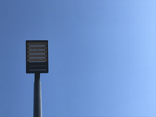 Street lamp over blue background. Sunny day.