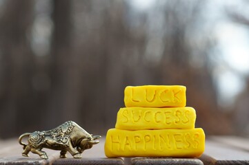 A metal bull figurine and the inscription happiness, luck, success.