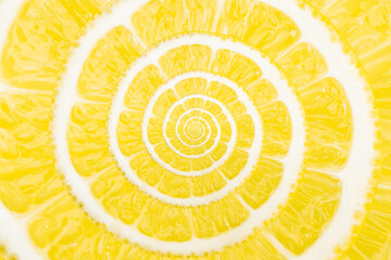 Spiral natural fruit fractal image. Top view of textured ripe slice of lemon citrus fruit with...