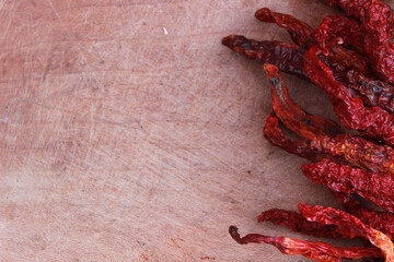 red hot chilies and wooden background copy space for your text.