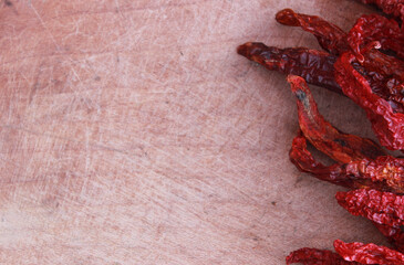 red hot chilies on the wooden background 