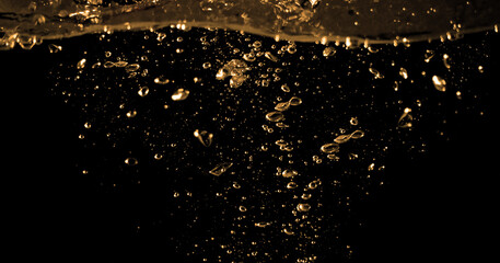 Oil liquid hi speed close up images from diesel gasoline. splashing and moving up to the air on black background. Power of fuel liquid that active and powerful. studio shot premium gold Oil concept. - obrazy, fototapety, plakaty