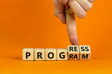 Progress and program symbol. Businessman turns wooden cubes and changes the word 'program' to 'progress'. Beautiful orange background. Business, progress and program concept. Copy space.
