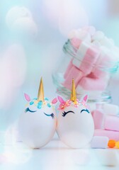 Easter composition with eggs and colorful sweets on light gray background