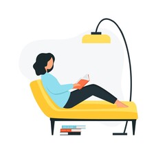 The girl sits on the sofa and reads a book. Young woman is resting in the room.