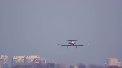 Business jet (bizjet or private jet) taking off (takes off) at sunset