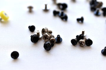Various bolts and nuts from appliances on a white background
