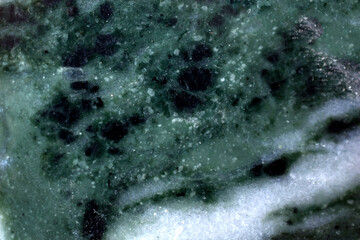 Green surface of granite and marble with streaks and cracks
