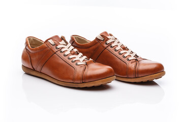 Pair of brown leather men's shoes on a white background.