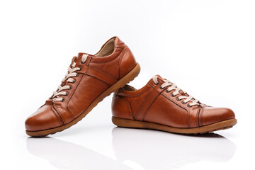 Pair of brown leather men's shoes on a white background.