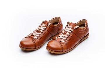 Pair of brown leather men's shoes on a white background.
