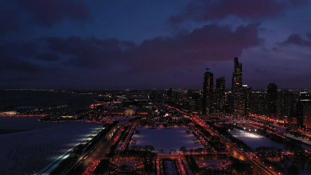 Chicago at Night in Winter and Lake Michigan. Blue Hour. Aerial View. United States of America. Drone Flies Forward