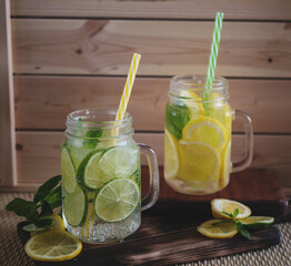 summer refreshing drink with lemon and lime in glasses