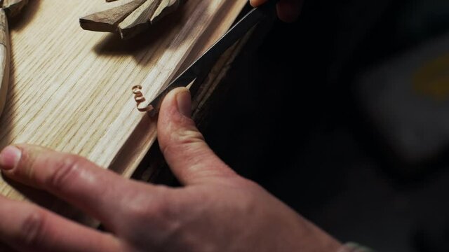 Close up of handsome joiner working with wood frame slow motion