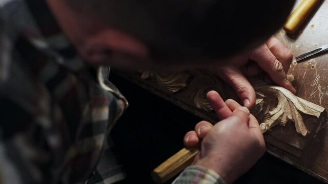 top view of handsome joiner working with wood frame slow motion