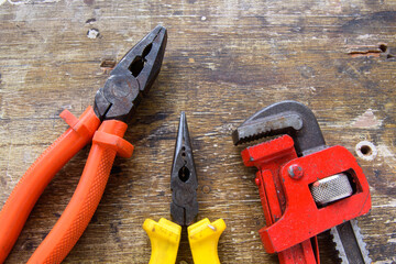 Pliers tool set on rustic wooden background