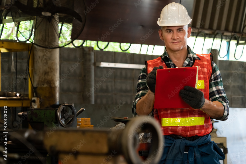 Poster manufacturing worker working with clipboard to do job procedure checklist . factory production line 