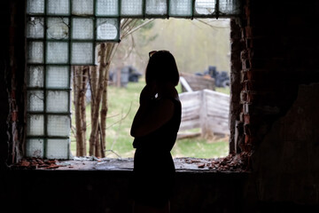 Unknown woman silhouette photo of girl figure in ruins background female posing in dark background