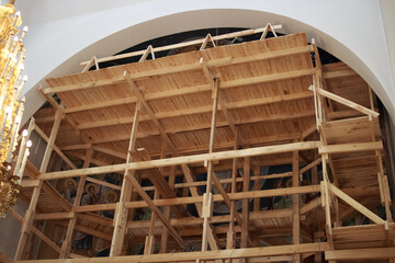 A newly constructed building of the church scaffolding cladding domes chandelier