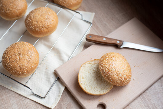 Cooking At Home, Sesame Hamburger Bun Cut In Half On A Board In The Kitchen.