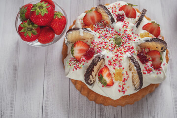 
photo of a baby cake with gummy bears and strawberries for birthday