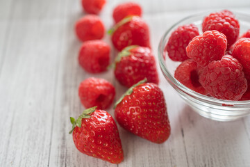 macro photography of strawberries and raspberries