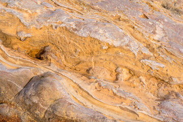 Light red-orange stone texture. Red orange grunge background. Mountain texture macro close-up. Bright colorful banner for your design.