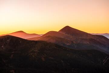 Fascinating summer sunset over green of mountains