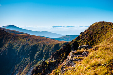 Natural background of mountains with fog on peaks