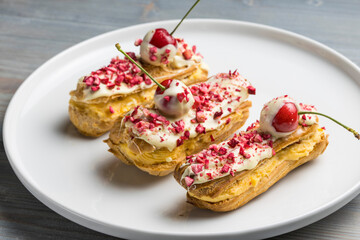 Traditional french eclairs with chocolate and Strawberry.