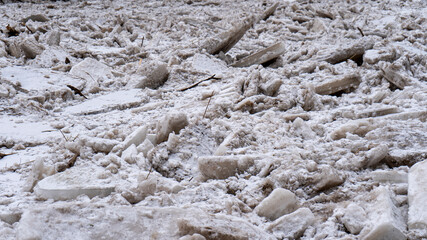 Huge Ice Loads Drift in the River Ogre, Latvia. Congestion on the River in the Spring. A Large Cluster of Moving Ice Blocks