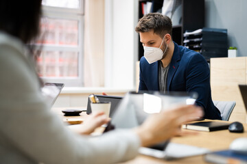 Man Employee In Office Wearing Face Mask Working