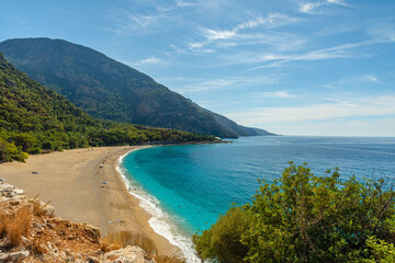 Kidrak beach with turquoise water near Oludeniz town on the coast of Mugla region in Turkey on summer day