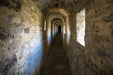 Old narrow warm stone tunnel in a medieval castle