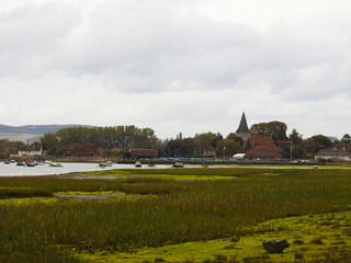 Flooding area with low green vegetation, water ,buildings and boats