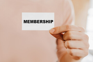 Man holding a business card with Membership