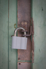 Padlock on an old wooden door.