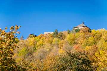 Naklejka premium Scenic view of ancient ruins of gothic and renaissance medieval royal castle, autumn landscape, sunny day, fortresses on hill, stronghold Tocnik, Central Bohemia, Czech Republic