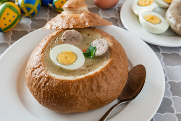 The sour soup (zurek) made of rye flour with sausage and egg served in bread bowl. Popular Easter dish.