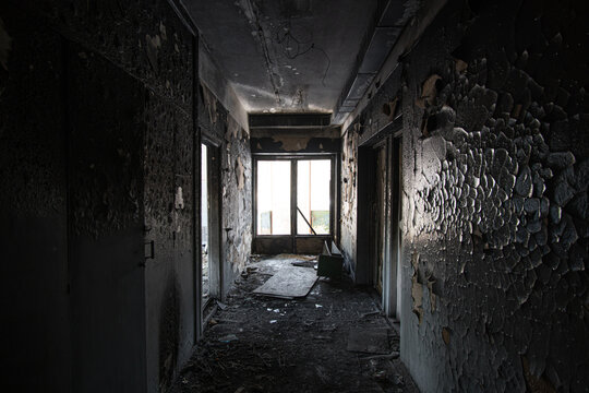 Corridor of the burned house where the fire took place with charred paint on the walls.
