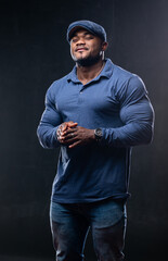 Muscular fitnessman posing in casual cloth. Stylish strongman wear blue clothes.