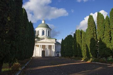All Saints church in Nizhyn, Chernihivska oblast, Ukraine. Beautiful old building XVIII century with dome for religious purposes, Orthodox Church. Ukrainian baroque architecture. Shady alley. Scenery.