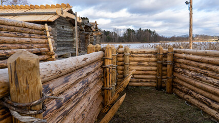 Araisi Lake Castle in Latvia. Historical Wooden Buildings on Small lake Island in the Frozen Lake Araisi in the Winter. Reconstruction of Wooden Fortified Settlement of Ancient European People