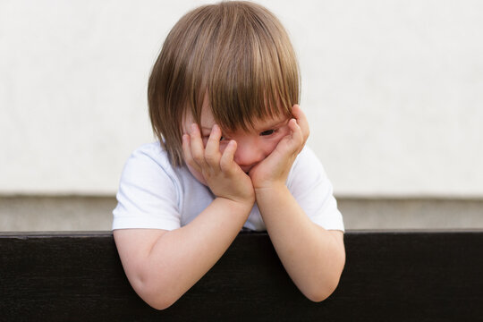 Blondy toddler with down syndrome warried during covid quarantine